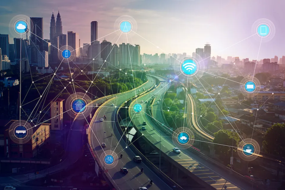 View of city skyline with overlay of icons indicating smart city connectivity.